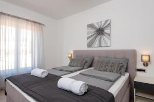 a bedroom with two beds with white pillows at Holiday Villa Olive Tree in Orebić +59 photos