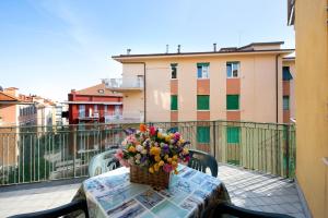 ein Blumenkorb auf einem Tisch auf einem Balkon in der Unterkunft Trilocale Mazzini con 2 balconi in Varraze