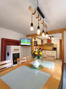 a kitchen and dining room with a vase of flowers on a table at Elto Wagau in Fusch an der Glocknerstraße