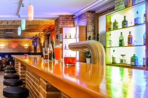 a bar with a wooden counter with a faucet at ibis Styles Berlin City Ost in Berlin