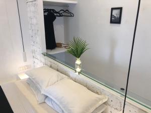 a room with a mirror and two pillows and a plant at Satta Beach Residence in Varkala