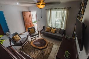 an aerial view of a living room with a couch and chairs at Casa Tulita Mérida in Mérida