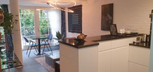 a kitchen with a counter and a dining room at Waar Maas & Waal..... in Woudrichem
