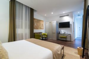 a hotel room with a bed and a desk at ICON Rosetó in Palma de Mallorca +32 photos