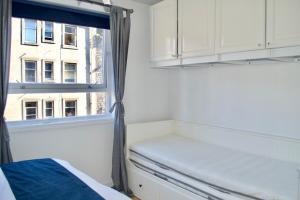 エディンバラにあるCentral and Spacious Flat - Royal Mileの窓とベッド、窓付きのベッドルーム1室