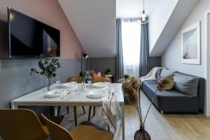 a living room with a table and a couch at Friendhouse Residence in Kraków
