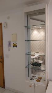 a glass display case in a white room with cookies at Kit no Lago Norte CA 02 in Brasilia