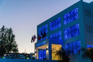 a building with blue lights on top of it at Hôtel Tamuda Beach in M'diq