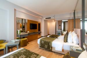 a hotel room with two beds and a desk at Oran Hotel in Istanbul