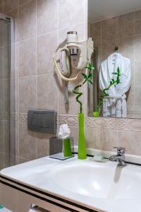 a bathroom with a sink and a mirror at Oran Hotel in Istanbul