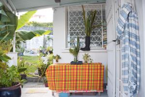 a patio with a table with plants on it at Mapi des Iles - chambre chez l'habitant in Le Gosier