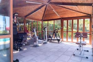 a gym with treadmills and ellipticals in a building at Agriturismo Cavalierino in Montepulciano