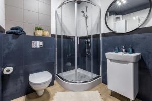 a bathroom with a shower and a toilet and a sink at Friendhouse Residence in Kraków +54 photos