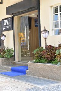 a blue carpet in front of a building at Ohm Village Inn(OVI) in Kitui