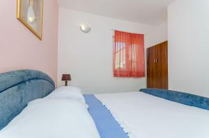 Postel nebo postele na pokoji v ubytování Apartments Zdenka