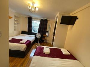A bed or beds in a room at Kings Cross Hotel London
