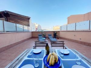 a table with bananas on top of a roof at Terracotta terrace in Barcelona