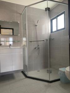 a bathroom with a shower with a glass door at Qingqing Yi Zhu in Magong