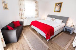 a bedroom with a large bed and a couch at Haus Farmer in Sankt Martin am Tennengebirge