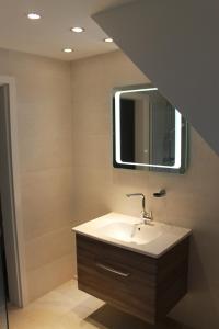 a bathroom with a sink and a mirror at Ferienwohnung Weserbergland in Hessisch Oldendorf +26 photos