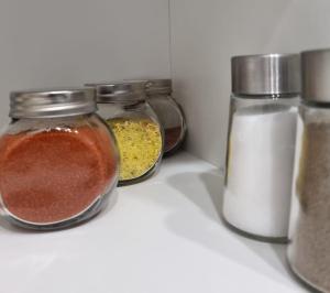 four jars of spices sitting on top of a shelf at Botanical garden in Zagreb +2 photos