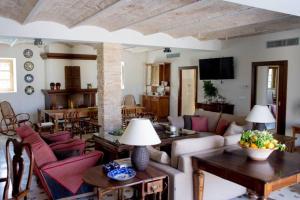 a living room with a couch and tables and chairs at Villa Luz Casa Valenciana in Alzira