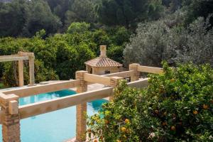 a villa with a swimming pool with an orange garden at Villa Luz Casa Valenciana in Alzira +16 photos