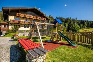 plac zabaw przed domem ze zjeżdżalnią w obiekcie Haus Farmer w mieście Sankt Martin am Tennengebirge