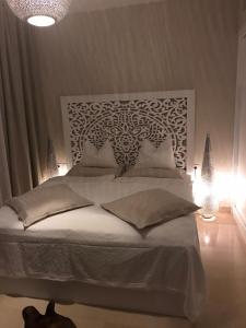a bedroom with a large white bed with lights at Jutta Deluxe 2-Bedroom-Apartment Mangroovy-M7 El Gouna in Hurghada +68 photos