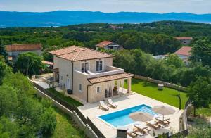 an aerial view of a villa with a swimming pool at Villa LuLu kamena villa s maslinikom otok Krk Dobrinj selo Gostinjac in Krk
