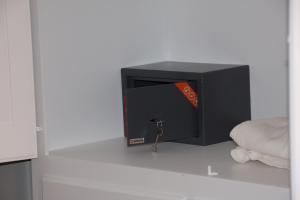 a black tv sitting on the floor with a book at L'Alloggio-Not just rooms in Olbia