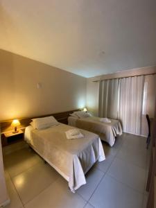 Cama ou camas em um quarto em Coimbra Hotel Pousada