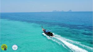 a boat in the middle of the ocean at Koh Ngai Kaimuk Thong Resort in Ko Ngai