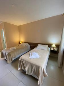 Cama ou camas em um quarto em Coimbra Hotel Pousada