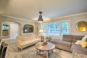 a living room with a couch and a table at Overland Park Home with Deck and Waterfall Pond! in Overland Park