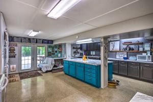 a kitchen with blue cabinets and a blue island at Mammoth Cave Rental on 50 Acres Shared Amenities in Cub Run