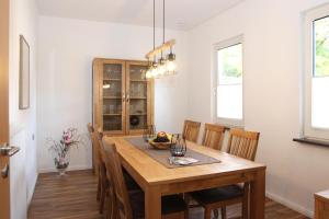 a dining room with a wooden table and chairs at Ferienwohnung Blum in Schmallenberg