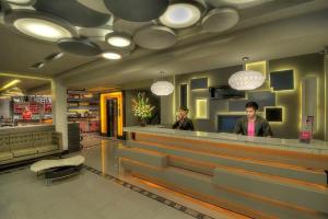 two people standing at a counter in a restaurant at Eloisa Royal Suites in Mactan +37 photos