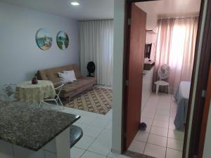 a living room with a couch and a table at Apartamento na orla de Maceió in Maceió