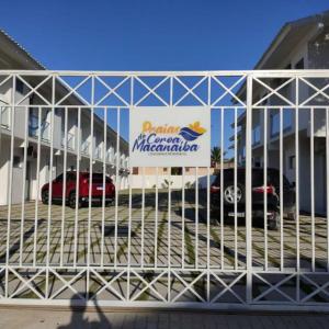 a car dealership with a sign on the front of it at Confortável Duplex a 100 Metros da Praia in Porto Seguro
