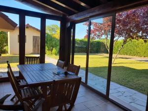 a dining room with a table and a view of a yard at El Rincon De Los Abuelos in Tudela de Duero