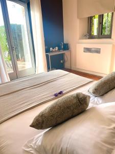 a bedroom with two beds with pillows and a window at Domaine de l'Enclos in Gordes