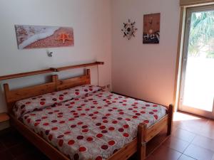 a bedroom with a bed with red roses on it at Maria's - Parking Area, no ZTL, close Train Station and Beach in Cefalù