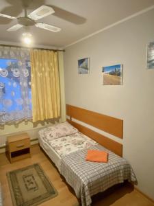 a bedroom with a bed and a ceiling fan at Hotelik Gościnny in Radzyń Podlaski
