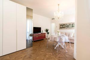 a living room with a table and a dining room at Madonna Montecchi Luxury Suite in Verona in Verona
