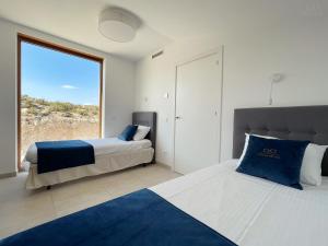 Tempat tidur dalam kamar di Colina del Sol Cullera - Villa Luna