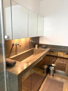 a kitchen with a large sink and white cabinets at Outstanding 2 bedrooms with a terrific Eiffel Tower view in Paris