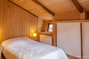 a bedroom with a bed in a wooden room at Boost Your Immo Les Deux Alpes 527 in Les Deux Alpes