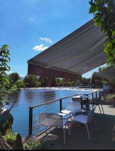 a picnic table in front of a large body of water at Hotel Opal Exclusive Bihać in Bihać