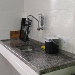 um balcão de cozinha com um lavatório num quarto em A Casa da Ilha de Itacuruçá - Aps em Flecheiras